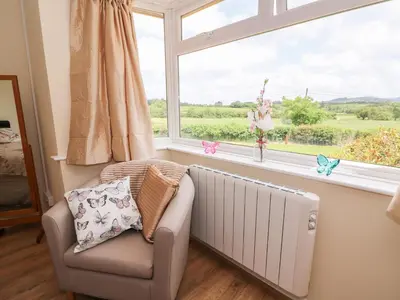 a living room with a radiator and a window at Tegfan in Rhayader
