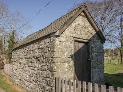 an old stone barn with a wooden door at Bicton Cottage in Acton