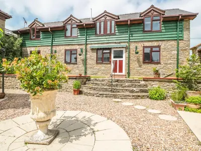 a house with a vase in front of it at The Courtyard in Kington