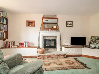 a living room with a fireplace and a tv at The Courtyard in Kington