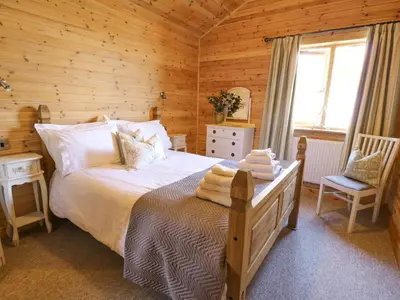 a bedroom with a bed in a wooden cabin at The Firs in Llanidloes
