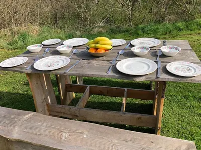 a wooden table with plates and bowls of fruit on it at The View in Welshpool