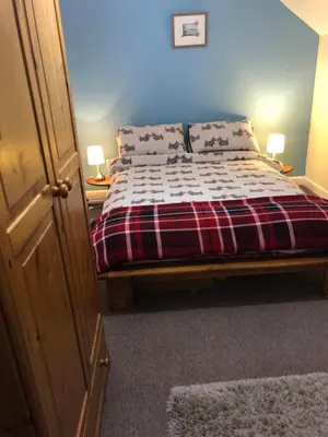 a bed in a room with two lamps on two tables at The View in Welshpool