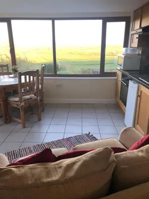 a living room with a couch and a table and windows at The View in Welshpool
