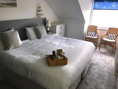 a bedroom with a large bed with a basket on it at Seabreeze Restaurant With Rooms in Aberdyfi