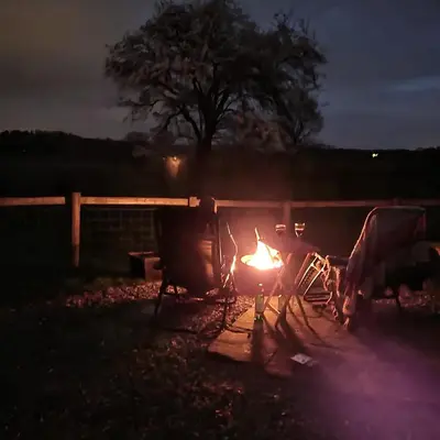 a fire burns in a yard at night at Ludlow Vintage Airstream in Ludlow