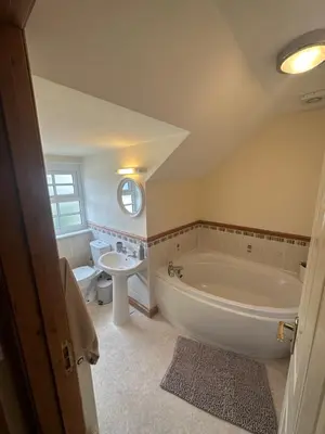 a bathroom with a large tub and a sink at Riverside in Brecon