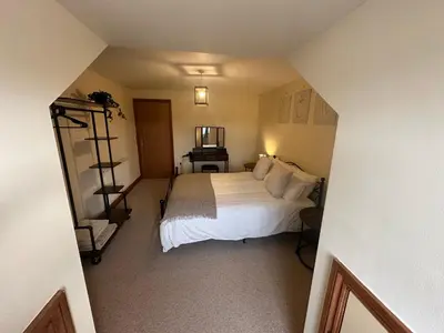 a bedroom with a large white bed in a room at Riverside in Brecon