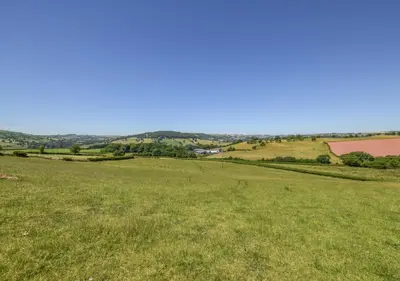 a field of green grass with a blue sky at 1 Bed in Nantygwreiddyn oc-bow49 in Sennybridge