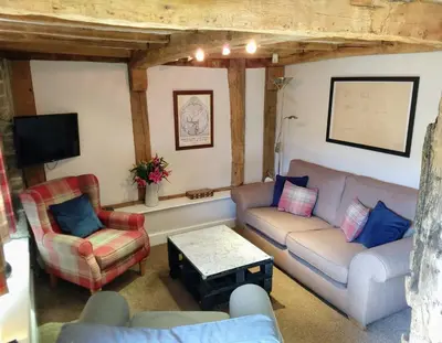 a living room with two couches and a tv at Little Drift in Edgton