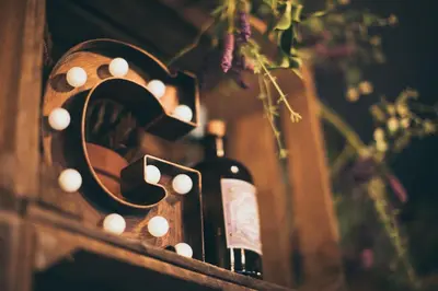 a bottle of wine sitting on a table with a mirror at Rowton Castle in Shrewsbury