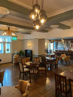 a dining room with tables and chairs and a restaurant at The Hand Hotel Llangollen by Compass Hospitality in Llangollen