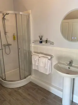 a bathroom with a shower and a sink at Black Mountain Lodge in Glasbury