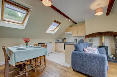 a kitchen and living room with a table and chairs at 2 Bed in Machynlleth oc-wad305 in Cemmaes