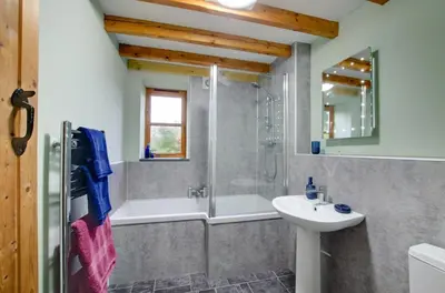 a bathroom with a tub and a sink and a shower at 2 Bed in Machynlleth oc-wad305 in Cemmaes