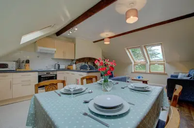 a kitchen and dining room with a table with plates on it at 2 Bed in Machynlleth oc-wad305 in Cemmaes