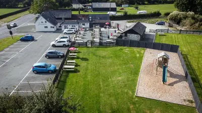 an aerial view of a park with cars parked in a parking lot at Smithy Cottage in Berriew