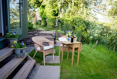 a table and chair with a laptop on it in a yard at GoldenValley Shepherd's Hut in Dorstone