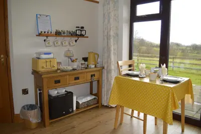 a dining room with a table and a table and a window at Smithfield Farm Bed & Breakfast in Builth Wells