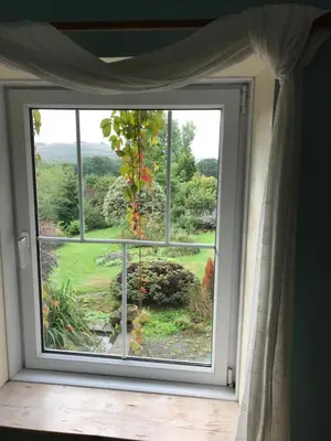 a window with a view of a garden at Pen y Crug Cottage in Llanafan-fawr