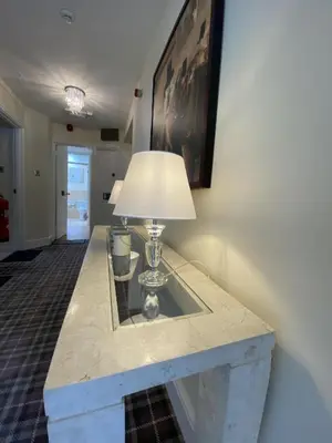a table with a lamp on top of it at Rooms at The Usk in Talybont