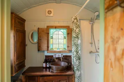 a kitchen with a sink and a window at Llethrau Forest & Nature Retreats in Knighton