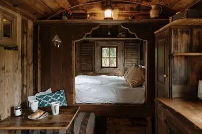 a bedroom with a bed in a wooden cabin at Llethrau Forest & Nature Retreats in Knighton