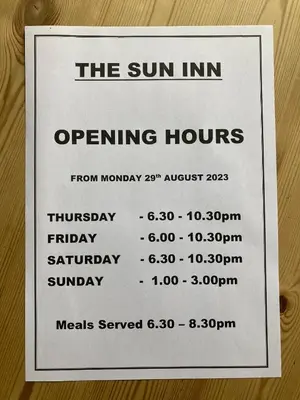 a sign that says the sun inn opening hours at Winforton B&B in Winforton
