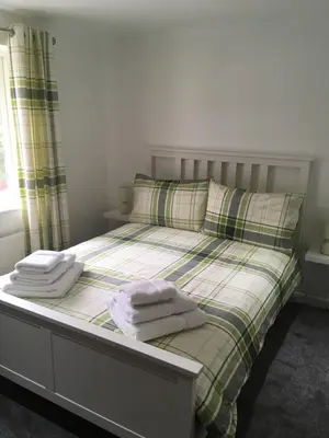 a bedroom with a bed with towels on it at Winforton B&B in Winforton