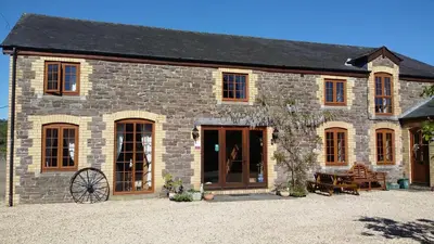 a large stone building with a large door at The Granary in Talgarth