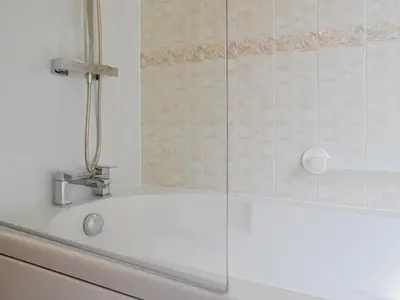 a bathroom with a shower with a white tub at Three Views Bungalow in Talgarth