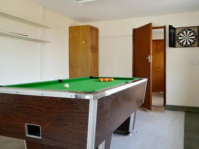 a pool table with balls on top of it at Three Views Bungalow in Talgarth
