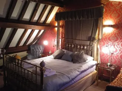 a bedroom with a canopy bed in a attic at The Kilverts Inn in Hay-on-Wye