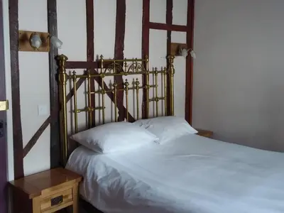 a bedroom with a bed with a wooden head board at The Kilverts Inn in Hay-on-Wye