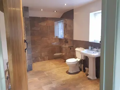 a bathroom with a toilet and a sink at Lletty Ann wynn at Fraithwen Cottages in Newtown