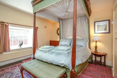 a bedroom with a canopy bed and a window at Colomendy in Montgomery