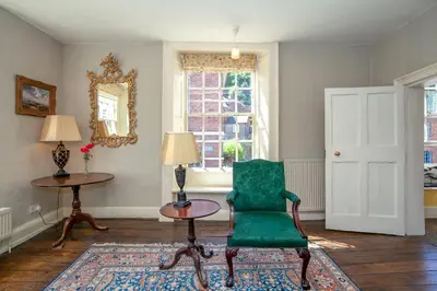 a living room with a green chair and a table at Colomendy in Montgomery