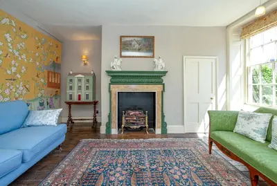 a living room with a blue couch and a fireplace at Colomendy in Montgomery