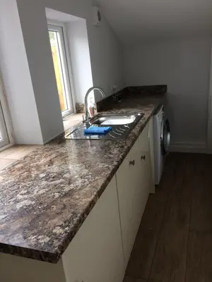 a kitchen with a sink and a counter top at Swyn y Mor beach close Pet friendly hot tub in Barmouth