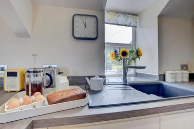 a kitchen with a counter with eggs and a clock at 2 Bed in Barmouth oc-bow52 in Llanaber