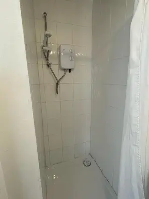 a bathroom with a shower with a toilet in it at Bryn Awel in Aberystwyth