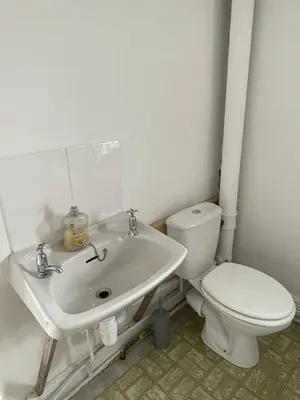 a bathroom with a white toilet and a sink at Bryn Awel in Aberystwyth