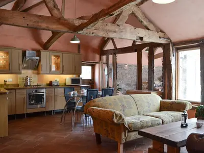 a living room with a couch and a table at The Cart Shed in Kings Pyon