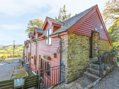 a small house with a red roof at Oak Cottage in Llanidloes