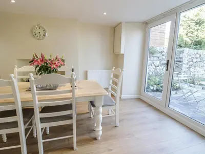 a dining room with a wooden table and chairs at Y Cilgwyn in Blaenau-Ffestiniog