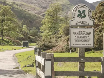 a sign on a fence next to a road at Old Hall Barn 1 in Church Stretton