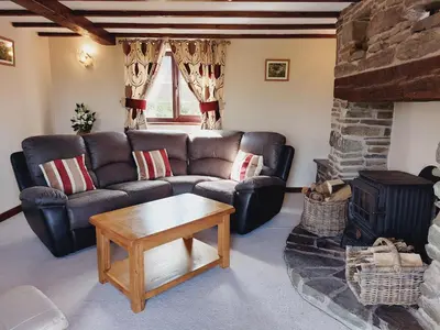 a living room with a couch and a fireplace at Waggoners Cottage in Montgomery