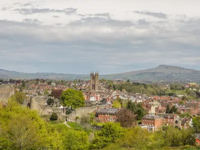 a cityscape of a town with a castle and trees at Garden Cottage in Ludlow