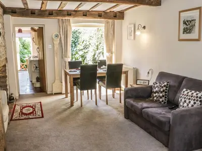 a living room with a couch and a table at Garden Cottage in Ludlow