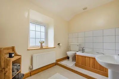 a bathroom with a tub and a toilet and a sink at Gwrtheyrn in Dyffryn